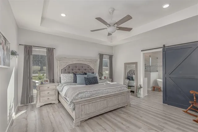 a bathroom with a granite countertop sink mirror vanity and toilet