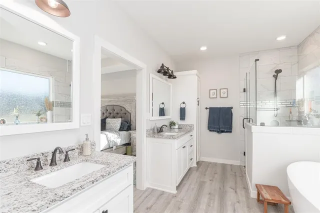 a bathroom with a tub sink and mirror