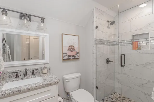 a bedroom with a bed a couch and dresser