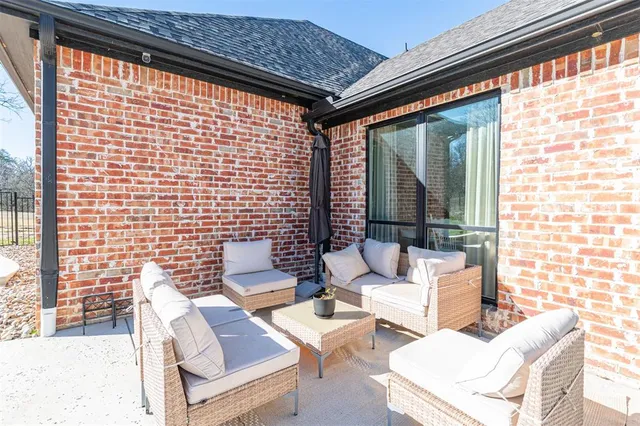 a view of a house with swimming pool and sitting area