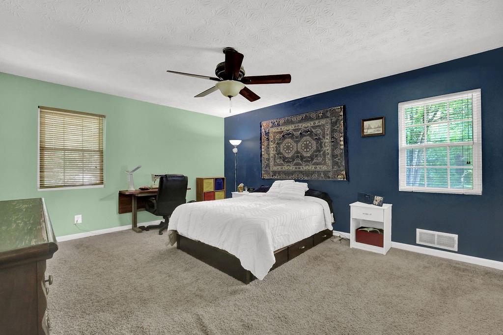 1555 Rock Springs Road Buford, GA 30519 - Photo 17 of 27 a bedroom with a large bed and a window