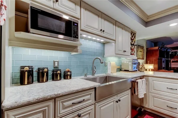 a kitchen with stainless steel appliances granite countertop a sink and stove