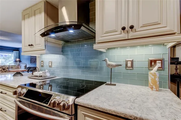 a kitchen with a stove and a refrigerator