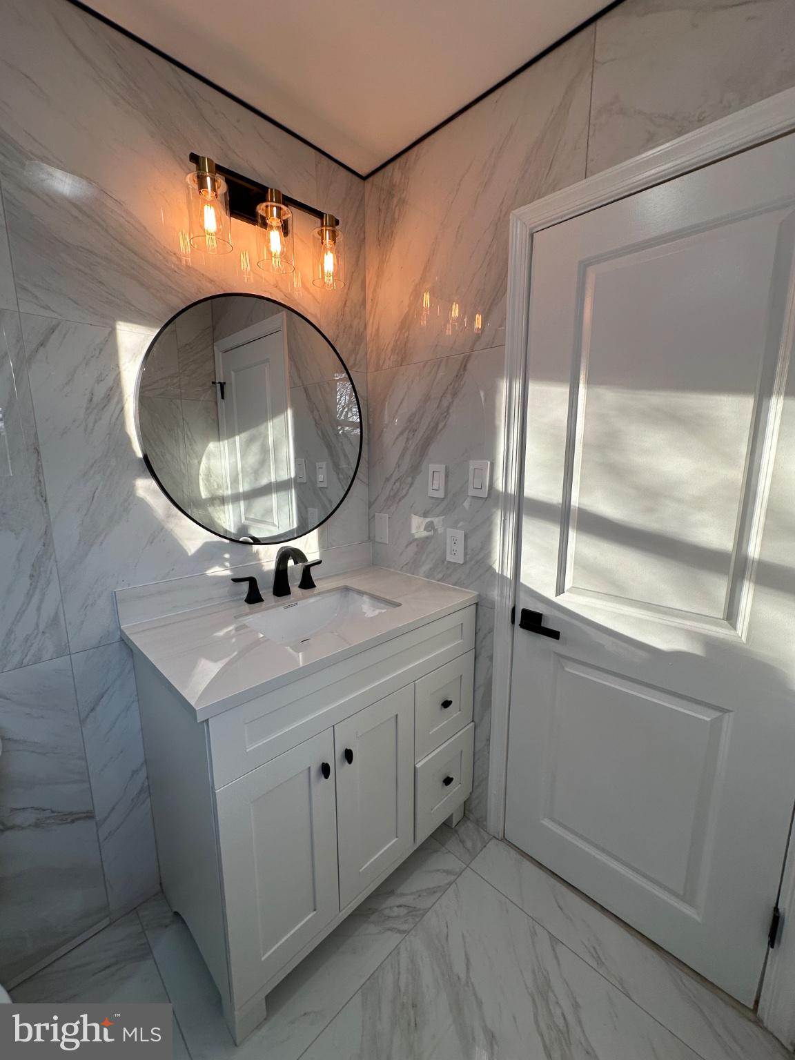 14 Buttonwood Road Voorhees, NJ 08043 - Photo 21 of 35 Sleek marble bathroom with modern accents.
