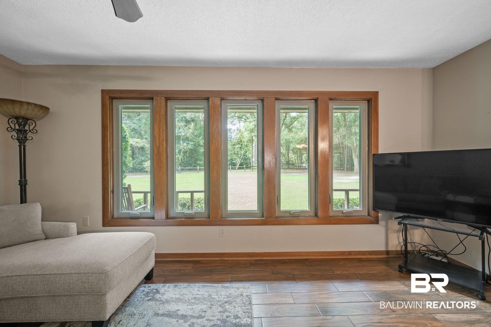4566 McCrary Road, Unit A Semmes, AL 36575 - Photo 12 of 28 Living room with dark wood-type flooring, plenty of natural light, and ceiling fan