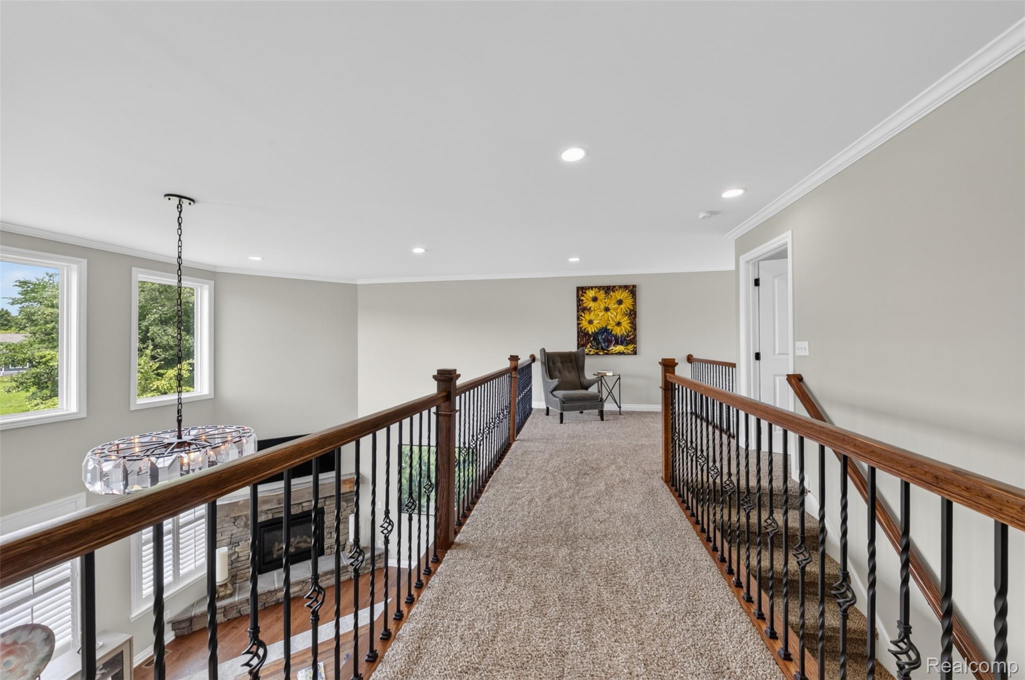 2531 Walnut View Drive Howell, MI 48855 - Photo 20 of 34 Carpeted loft area featuring wrought iron and wood railings, recessed lighting, and crown molding