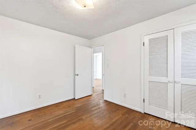 a view of a chair and table in backyard of the house