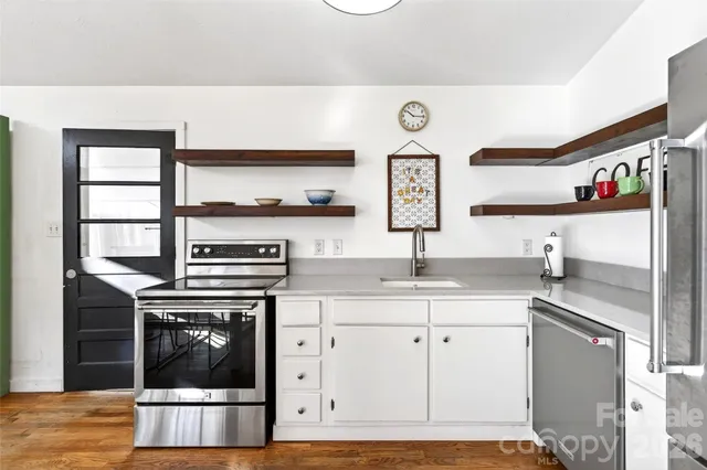 a view of a living room and kitchen floor to ceiling window