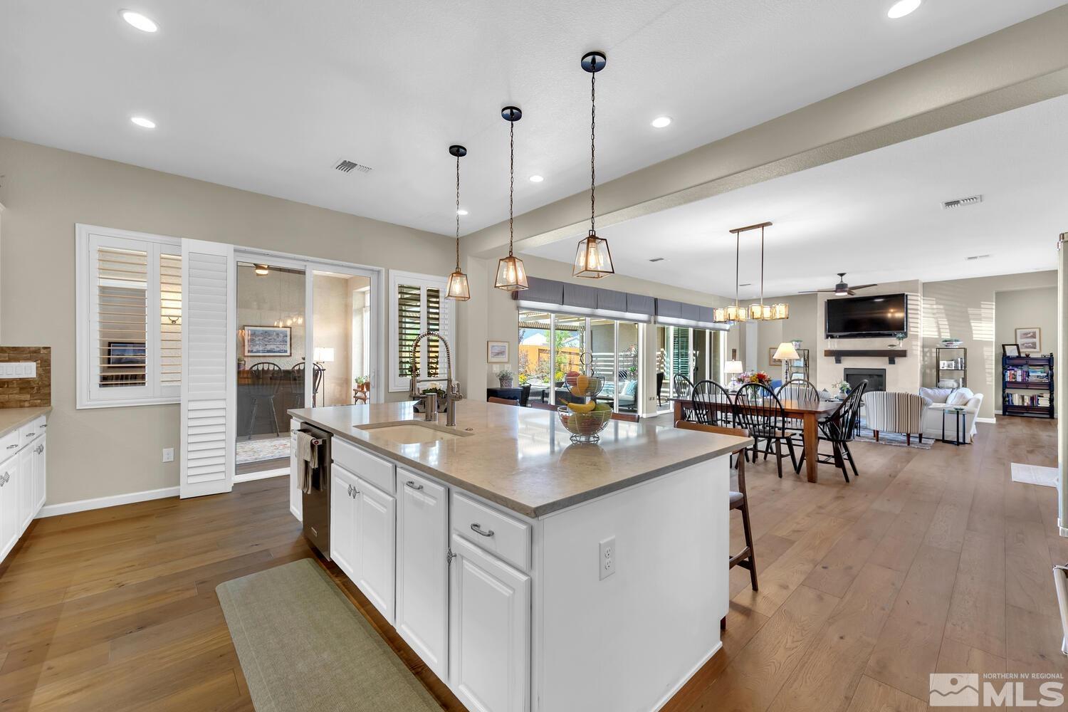 9775 Thesolious Lane Reno, NV 89521 - Photo 12 of 40 a kitchen with stainless steel appliances granite countertop counter space a sink and living room view