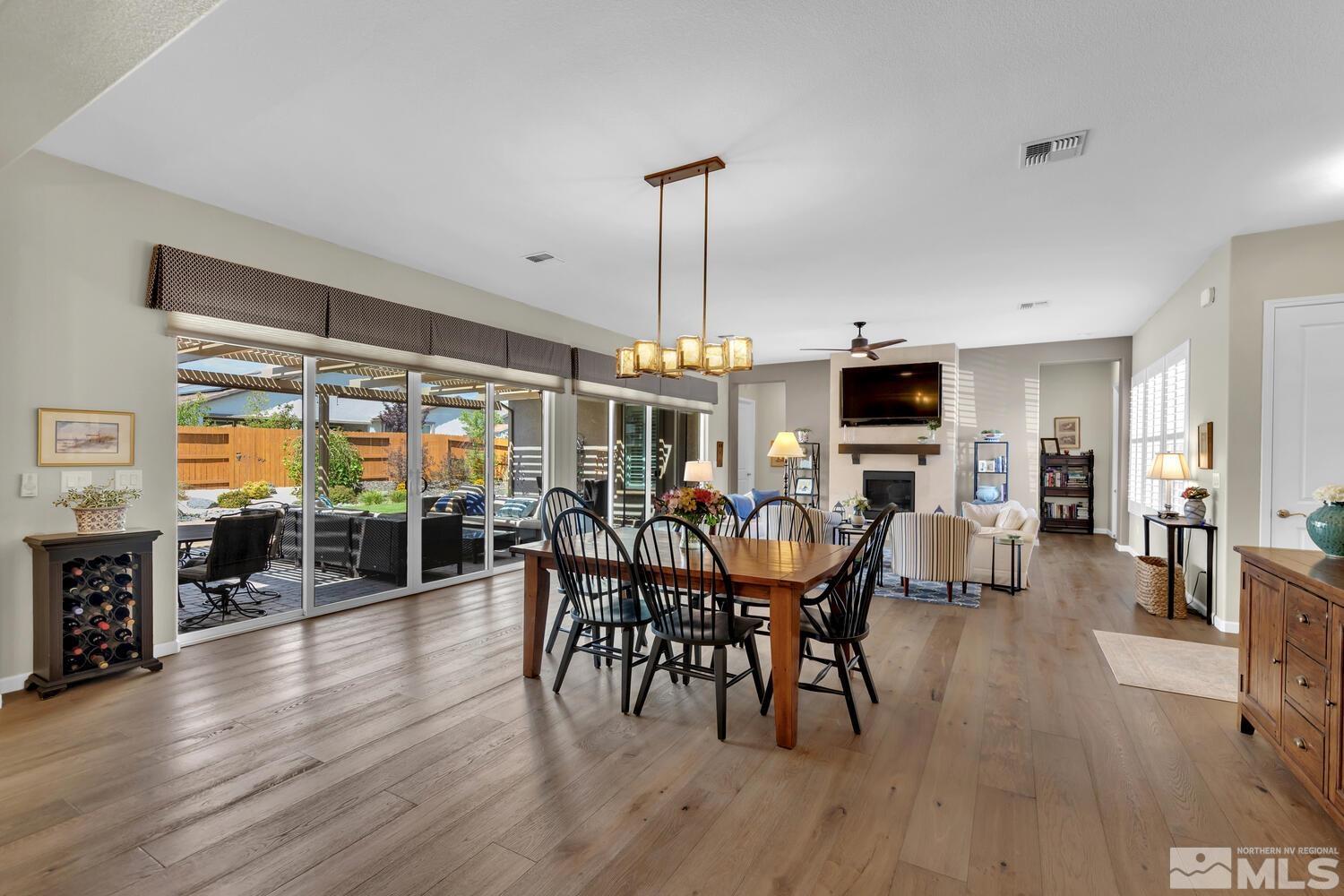 9775 Thesolious Lane Reno, NV 89521 - Photo 13 of 40 a view of a dining room with furniture window and wooden floor