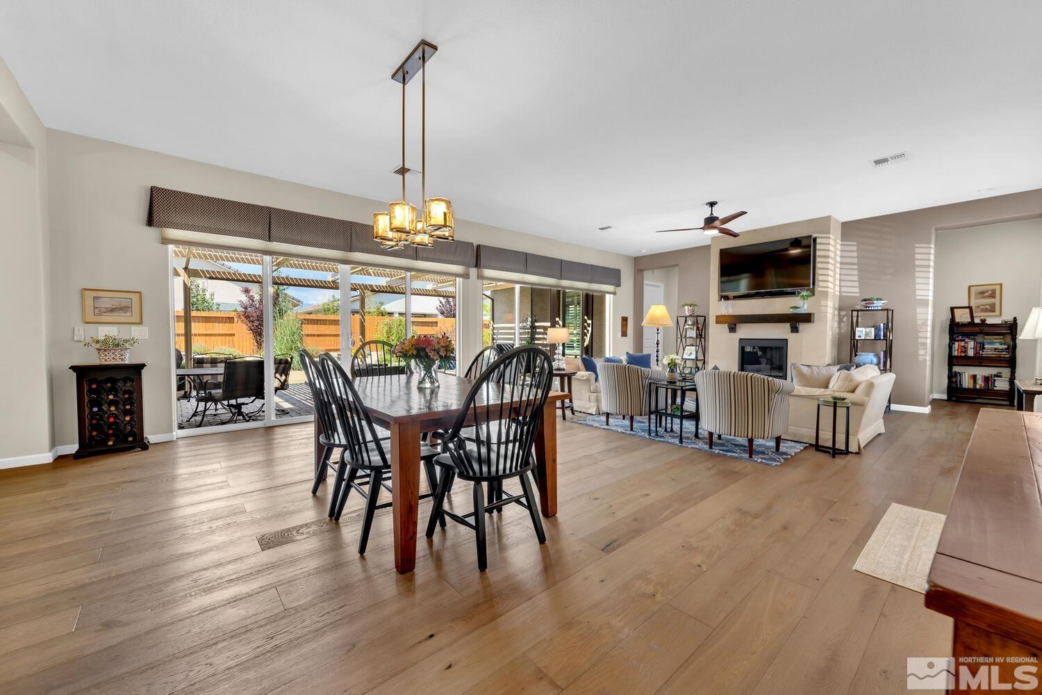 9775 Thesolious Lane Reno, NV 89521 - Photo 15 of 40 a view of a dining room with furniture window and wooden floor