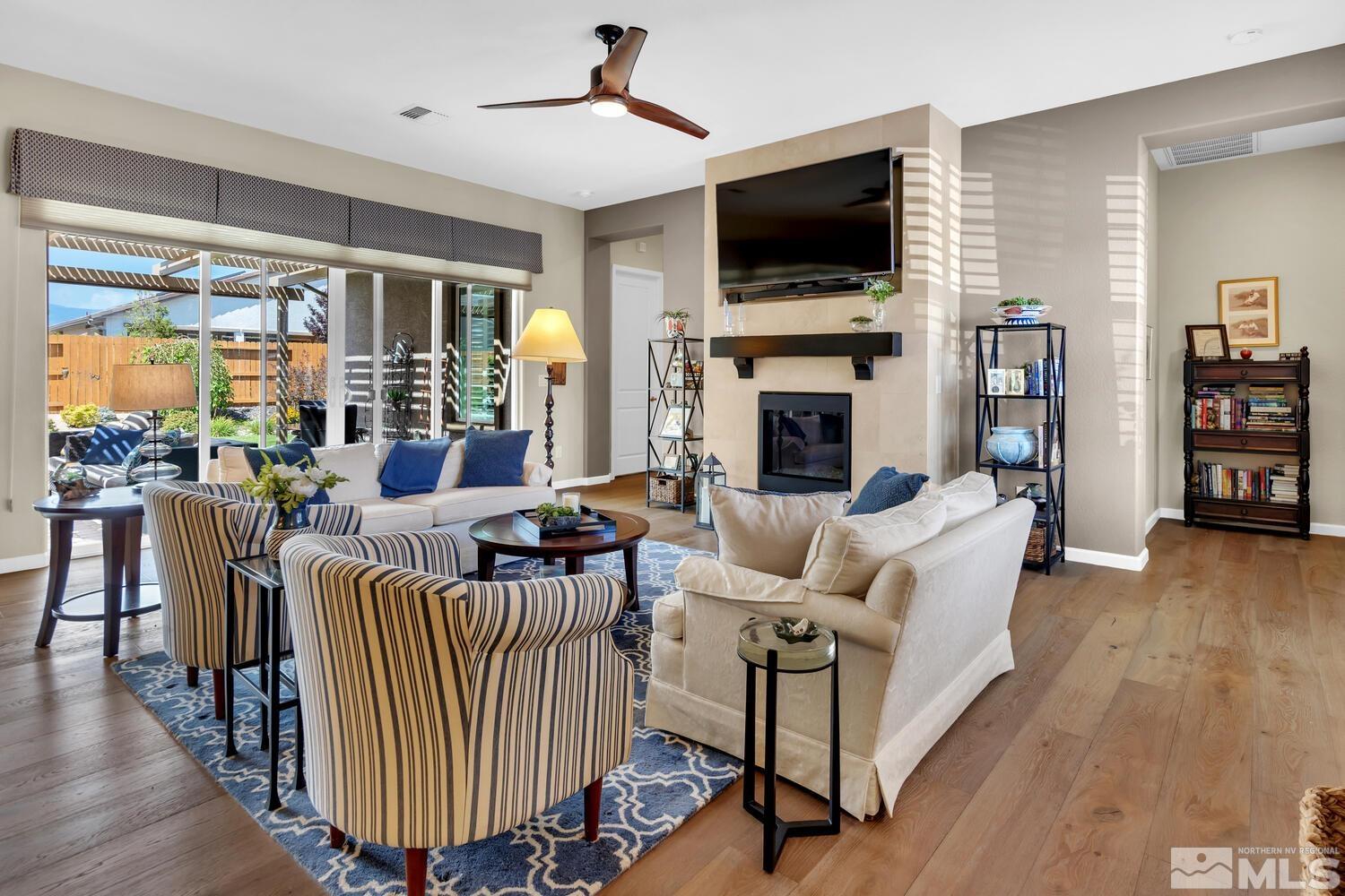 9775 Thesolious Lane Reno, NV 89521 - Photo 16 of 40 a living room with fireplace furniture and a flat screen tv