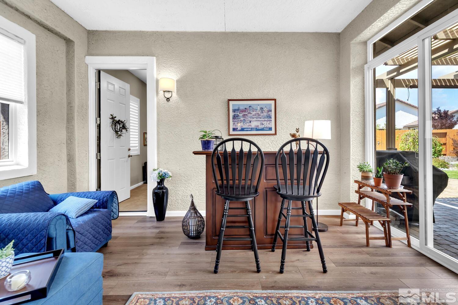 9775 Thesolious Lane Reno, NV 89521 - Photo 20 of 40 a living room with furniture a wooden floor and a large window
