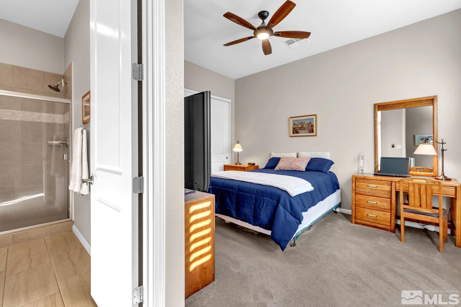 9775 Thesolious Lane Reno, NV 89521 - Photo 24 of 40 a bedroom with a bed and a chandelier