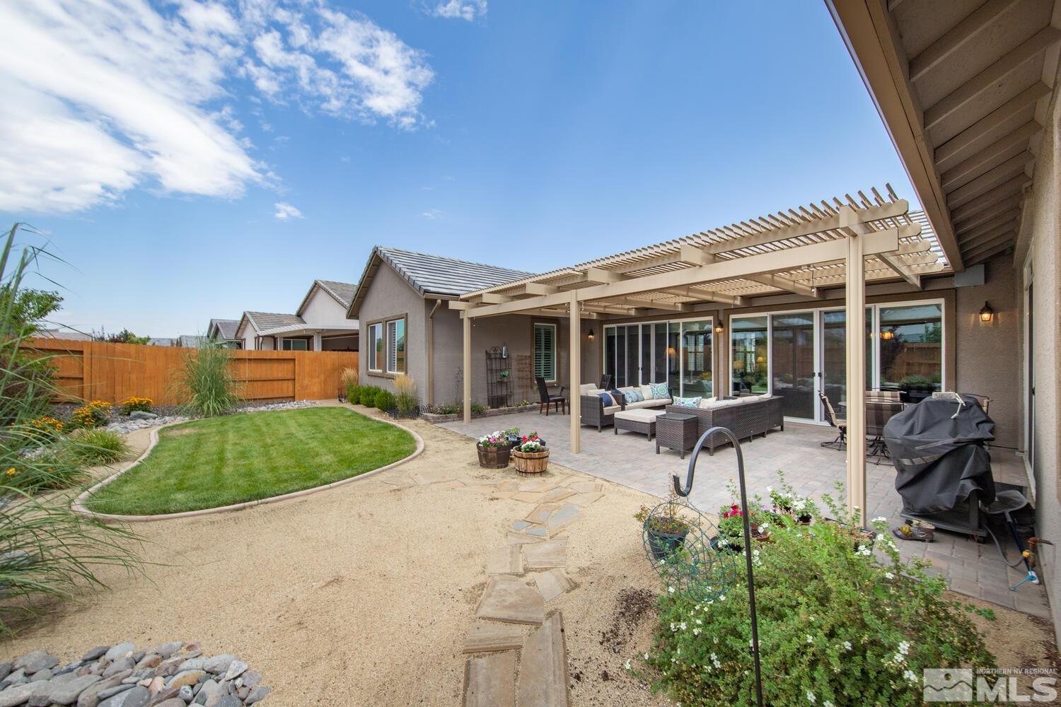 9775 Thesolious Lane Reno, NV 89521 - Photo 34 of 40 a house view with outdoor seating space and garden