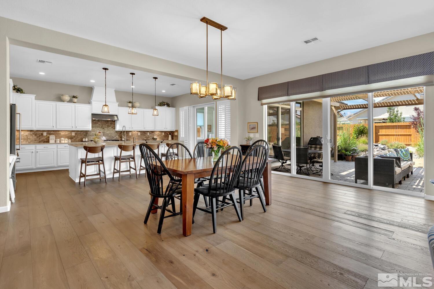 9775 Thesolious Lane Reno, NV 89521 - Photo 5 of 40 a view of a dining room with furniture window and wooden floor