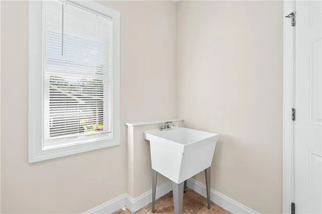 a view of a room that has a window and a table in it