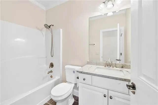 a bathroom with a sink a toilet a mirror and shower