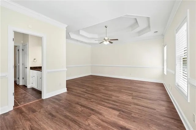a view of empty room with wooden floor and window