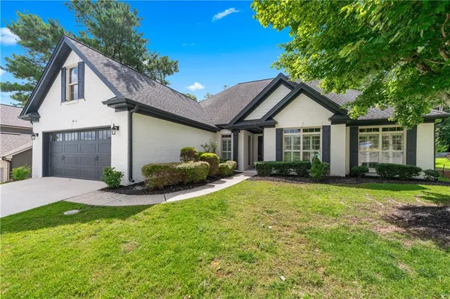 a view of a house with a patio and yard