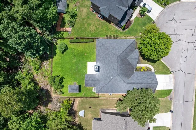 an aerial view of a house with a yard