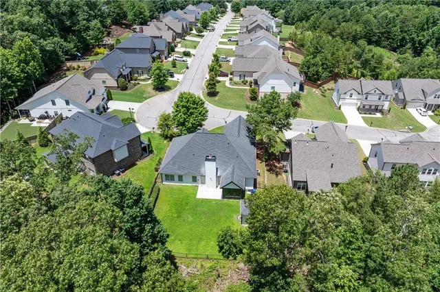 an aerial view of multiple houses with yard