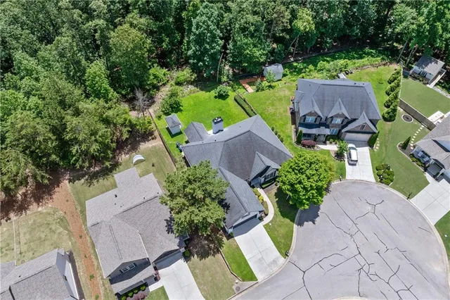 an aerial view of a house with garden space and a yard