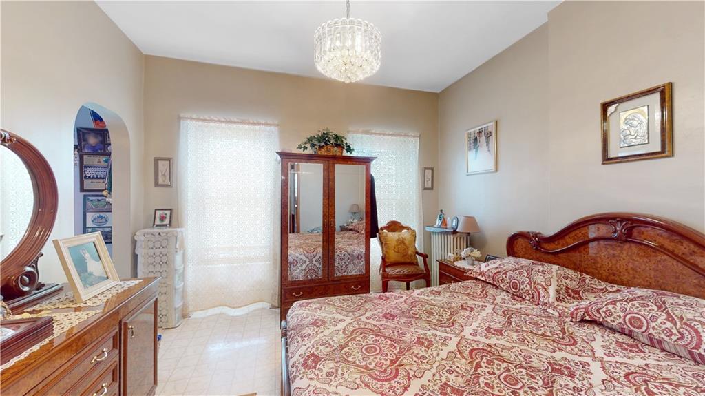 29 3rd Place Brooklyn, NY 11231 - Photo 10 of 25 a bedroom with a bed a chandelier and dresser