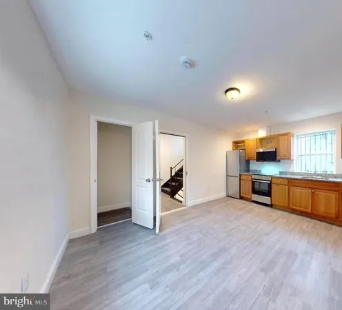 a view of a kitchen with a sink and a window