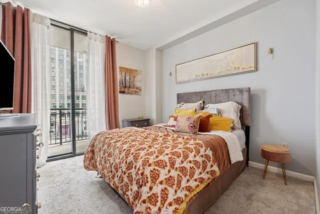 a bedroom with a bed and large window