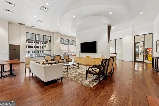 a living room with furniture wooden floor and a flat screen tv