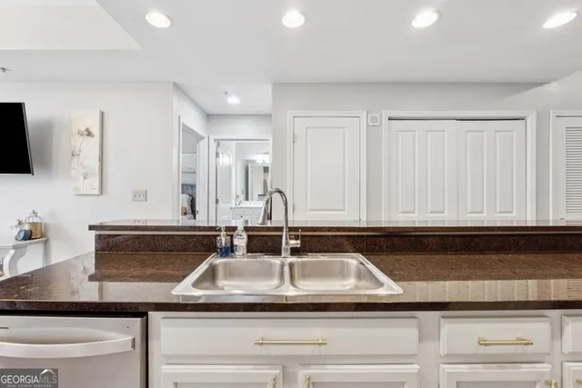 a kitchen with sink and cabinets