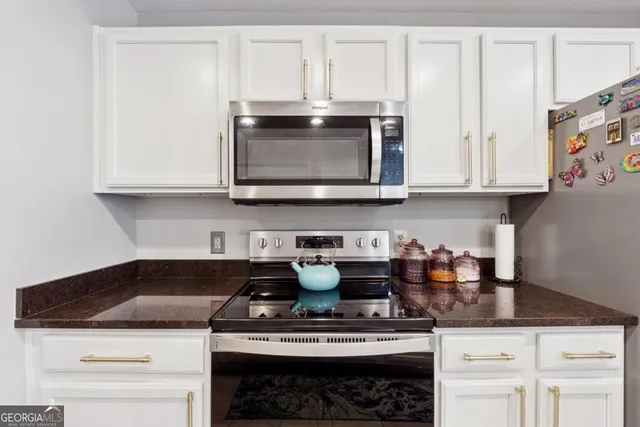 a stove top oven sitting inside of a kitchen