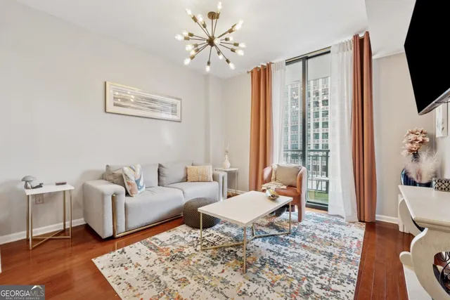 a living room with furniture a rug and a flat screen tv