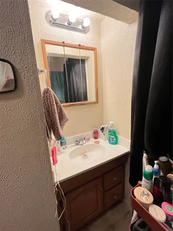 a bathroom with a sink vanity and mirror