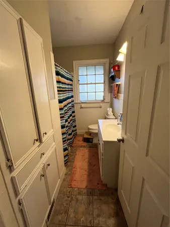 a view of a hallway with wooden floor and stairs