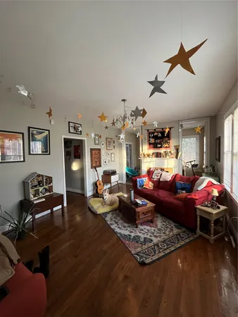 a living room with furniture rug and window