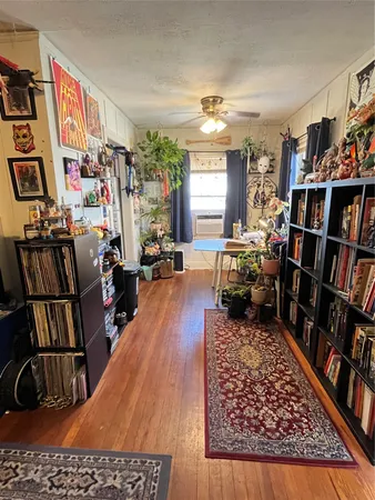 a living room with furniture and a book shelf