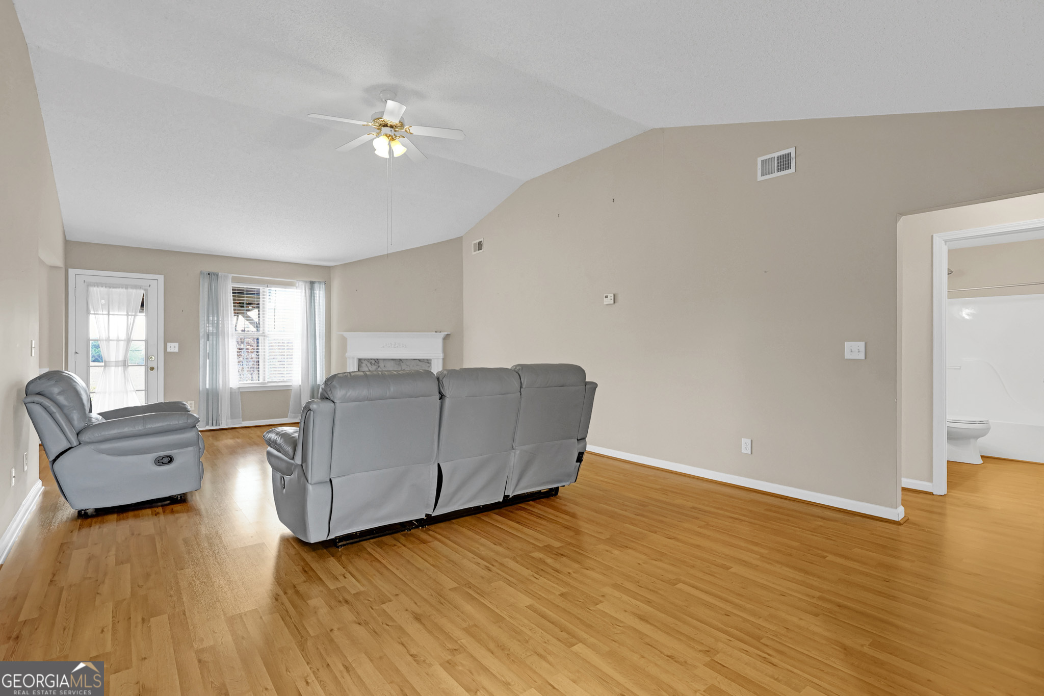 313 Harris Avenue Locust Grove, GA 30248 - Photo 12 of 34 a living room with furniture and a wooden floor