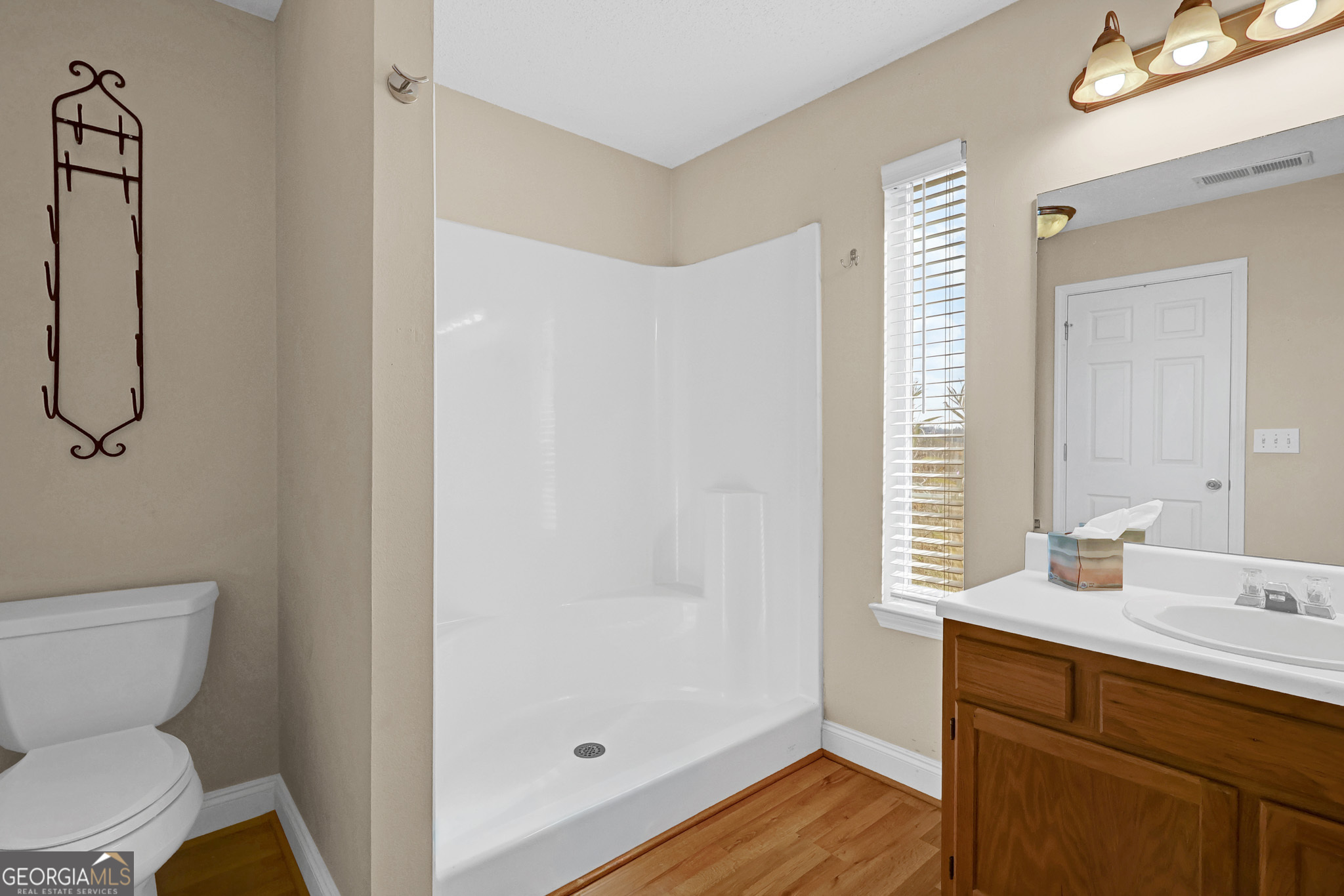 313 Harris Avenue Locust Grove, GA 30248 - Photo 17 of 34 a bathroom with a sink toilet and shower