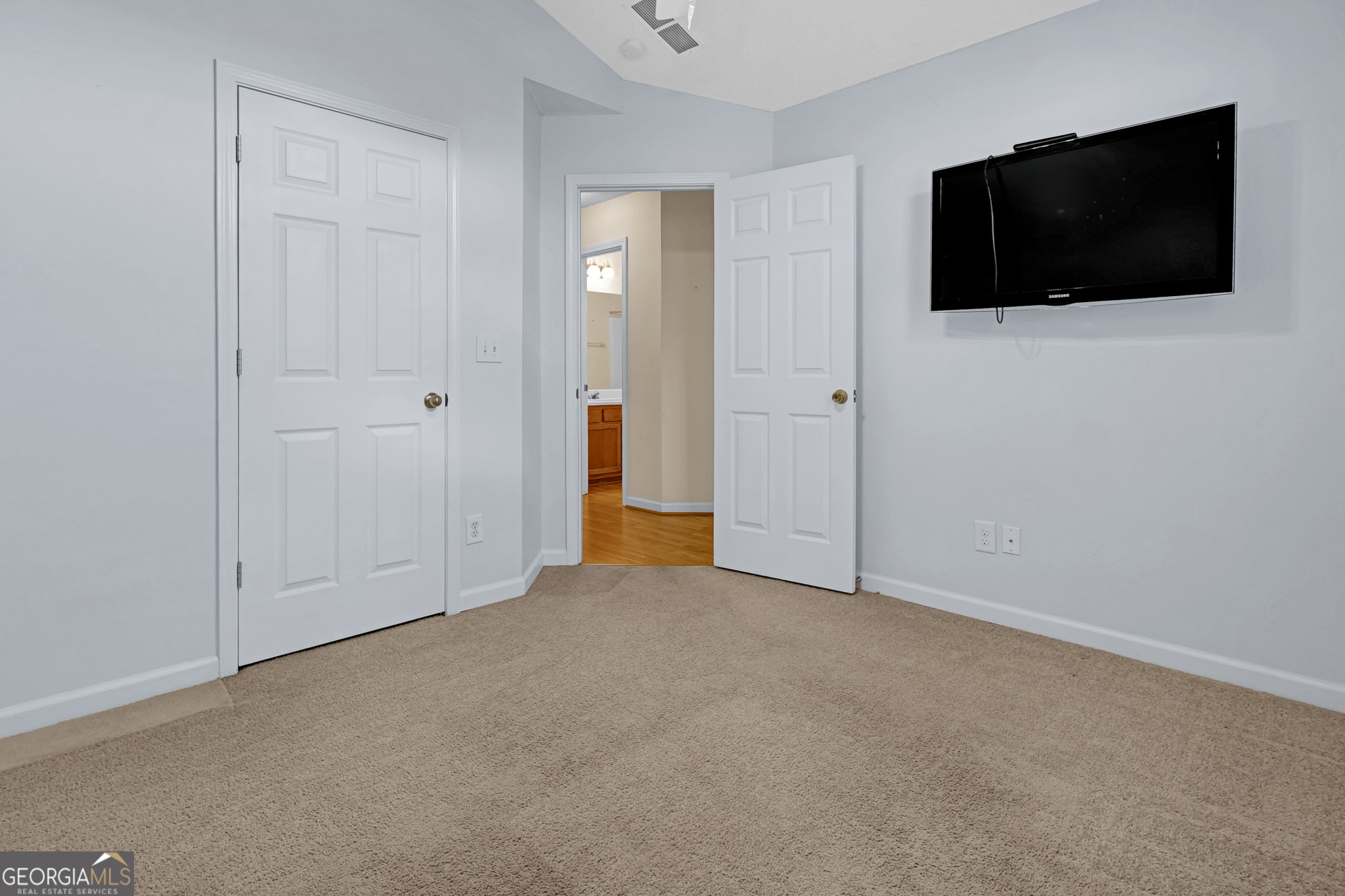 313 Harris Avenue Locust Grove, GA 30248 - Photo 19 of 34 a view of a livingroom with a flat screen tv and closet