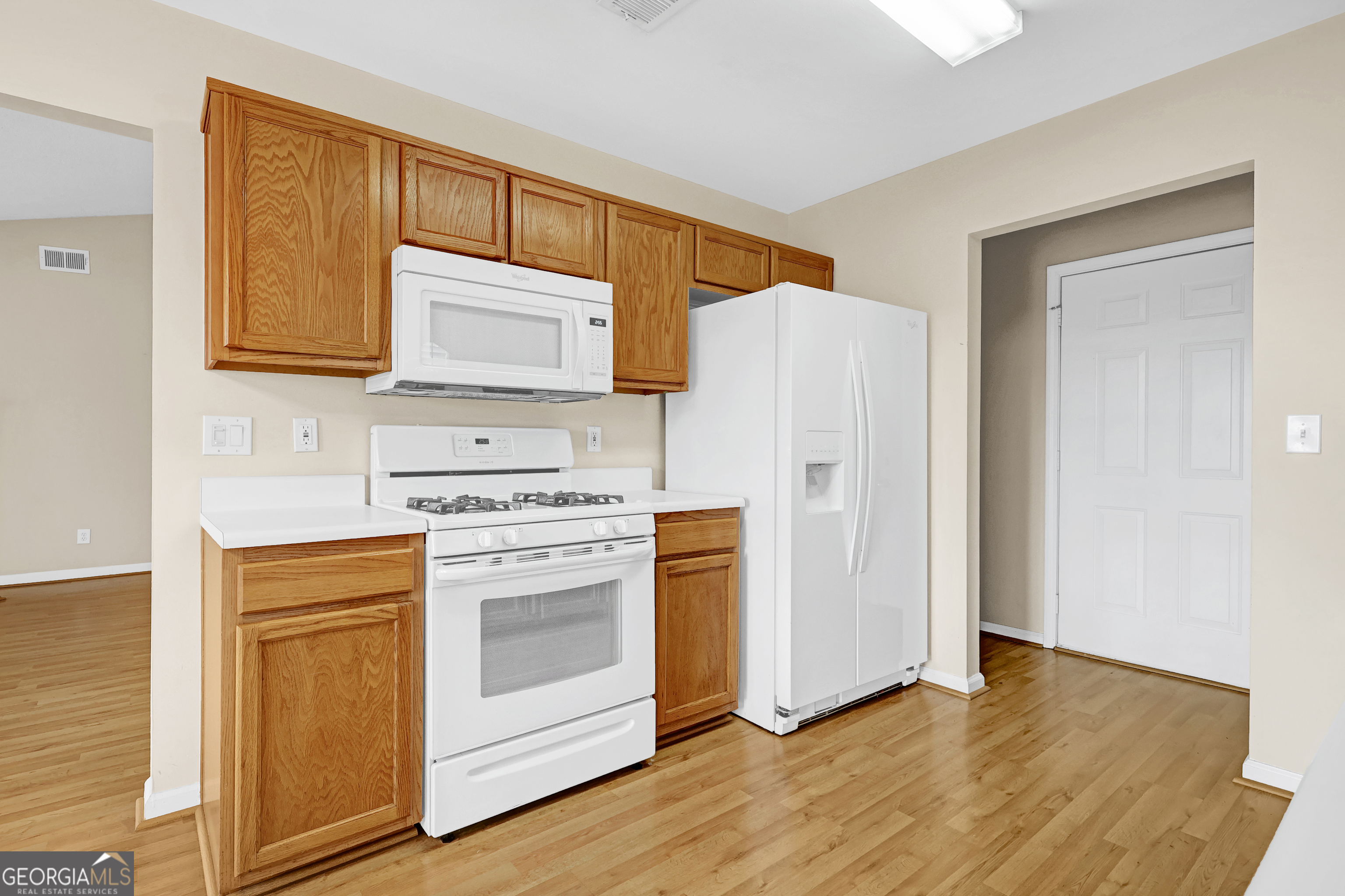 313 Harris Avenue Locust Grove, GA 30248 - Photo 24 of 34 a kitchen with a refrigerator stove and sink