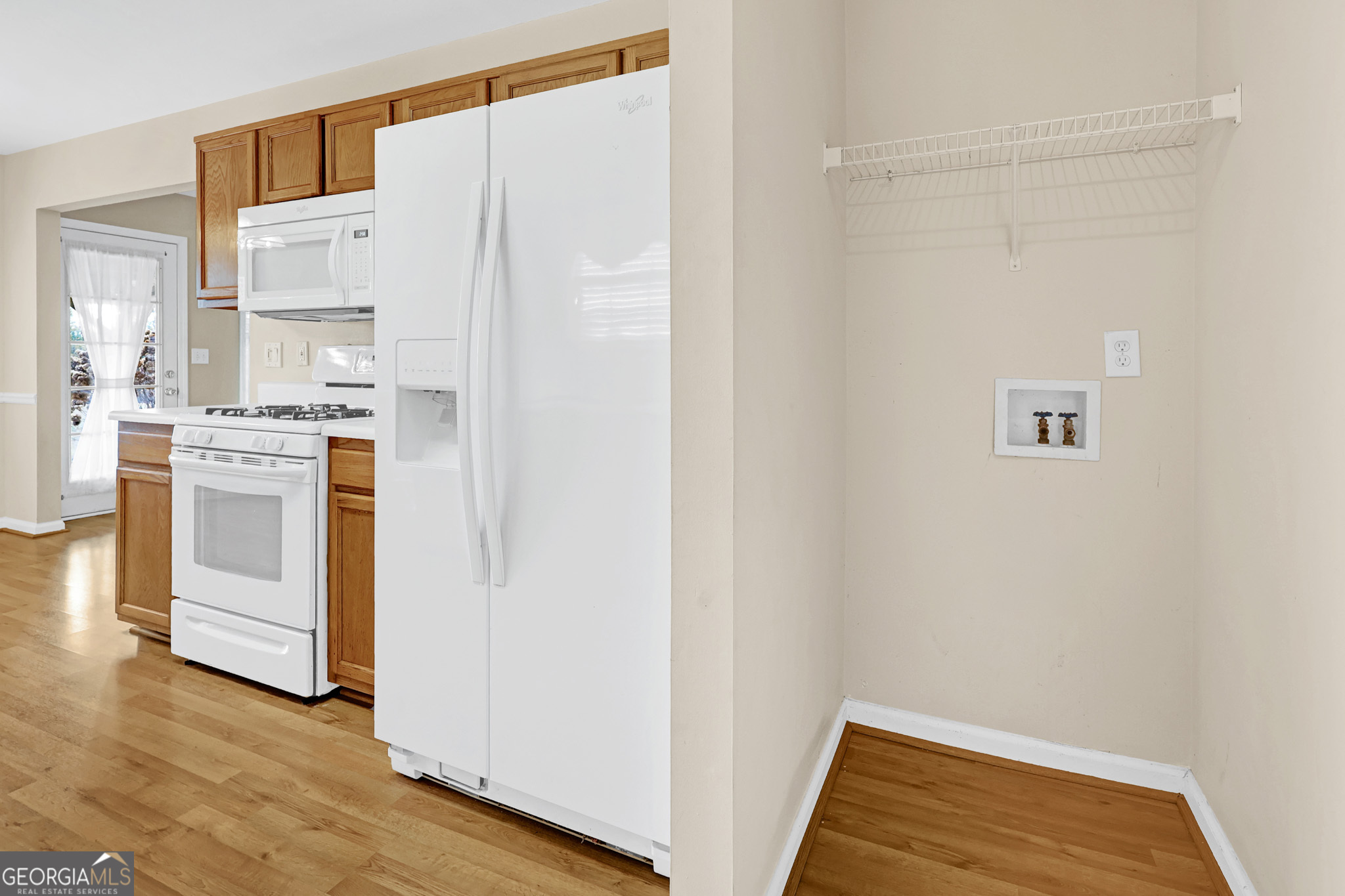 313 Harris Avenue Locust Grove, GA 30248 - Photo 25 of 34 a view of a kitchen with white cabinets and wooden floor