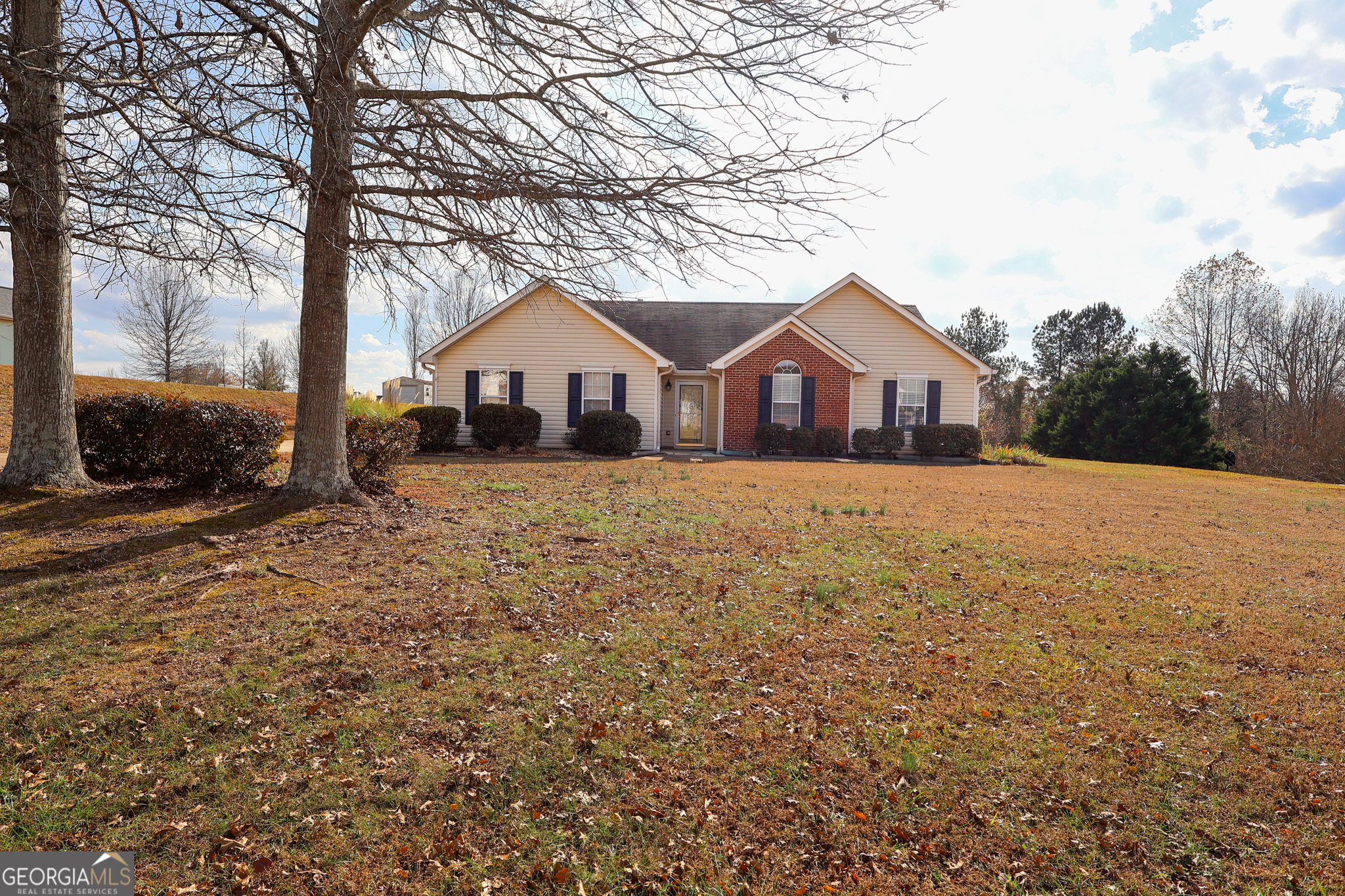 313 Harris Avenue Locust Grove, GA 30248 - Photo 3 of 34 a front view of a house with a yard covered in snow