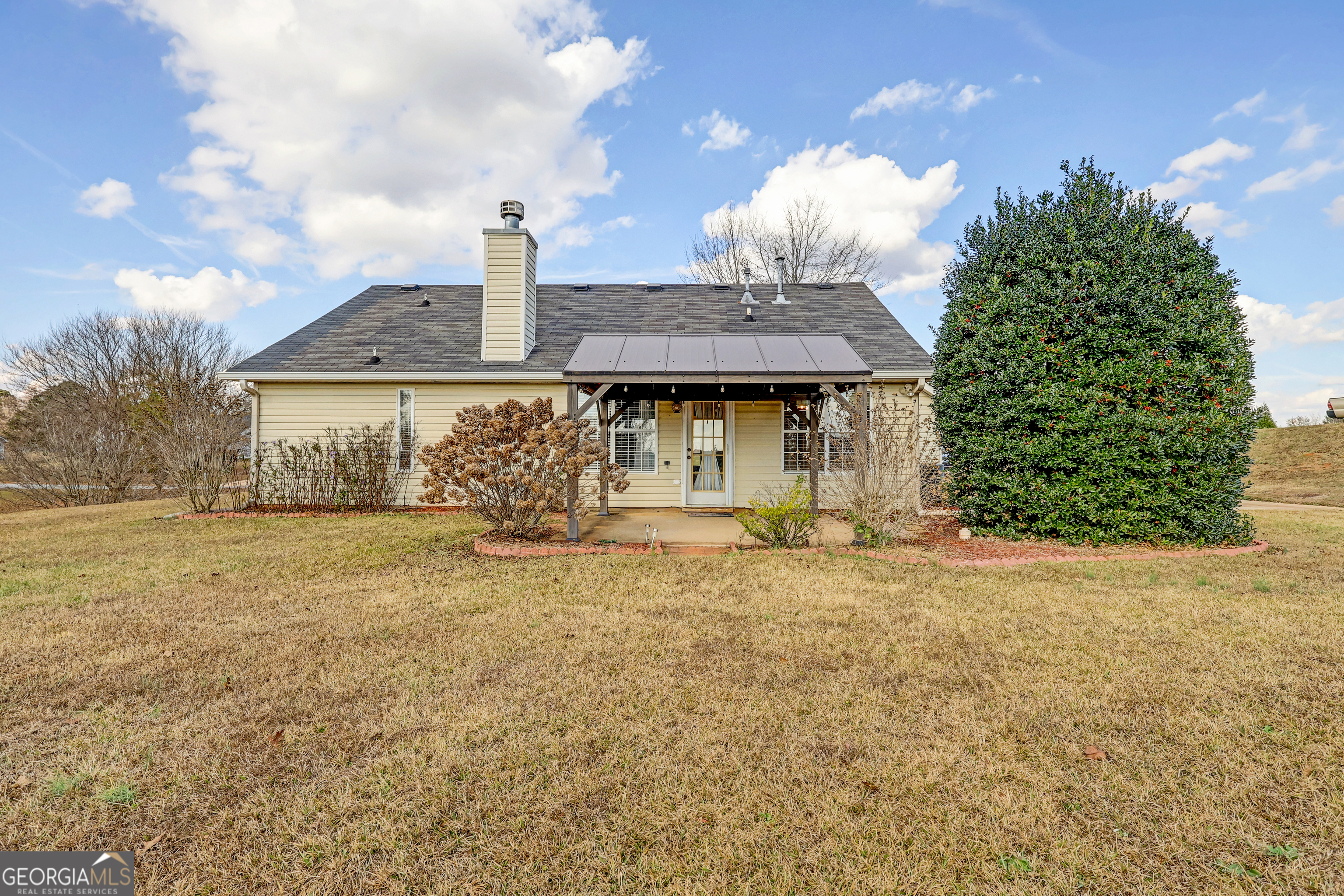 313 Harris Avenue Locust Grove, GA 30248 - Photo 32 of 34 a front view of a house with a garden and trees