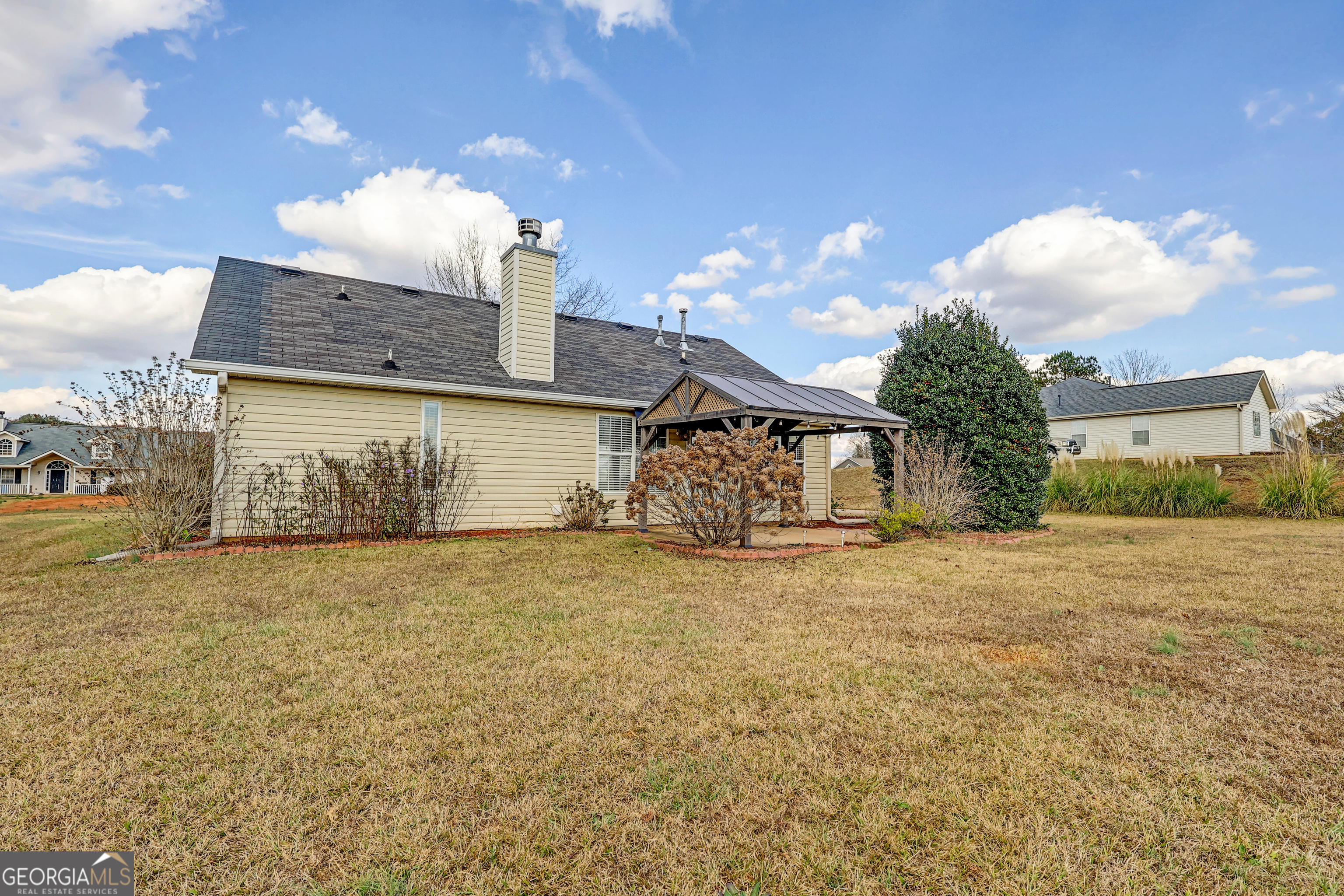 313 Harris Avenue Locust Grove, GA 30248 - Photo 33 of 34 a view of a house with a yard and garage