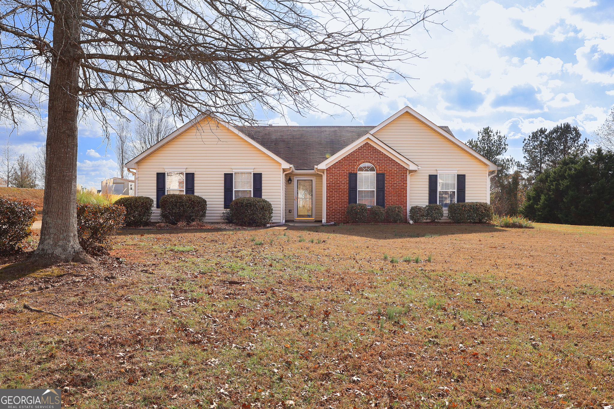 313 Harris Avenue Locust Grove, GA 30248 - Photo 4 of 34 a front view of a house with a yard covered in snow