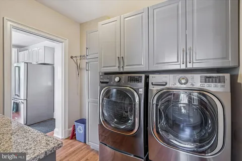 a utility room with sink dryer and washer