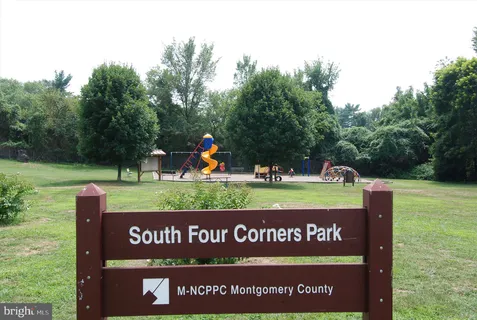 a picture of a bench in front of a white house