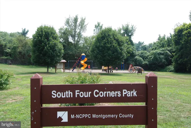 a picture of a bench in front of a white house